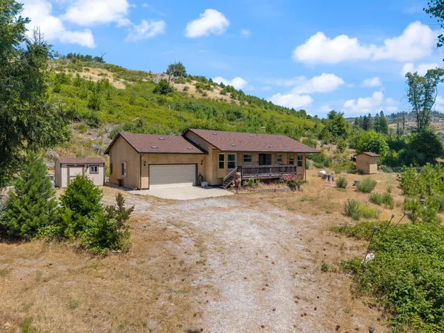 a view of a house with wooden floor and a yard