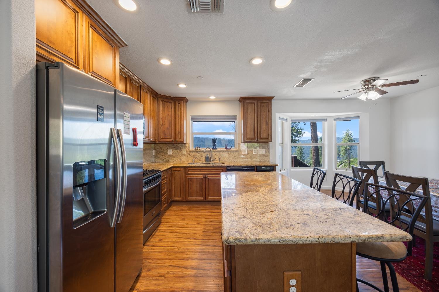 8009 Spring Valley Road Pollock Pines, CA 95726 - Photo 11 of 31 a large kitchen with stainless steel appliances granite countertop a large counter top a stove and a refrigerator