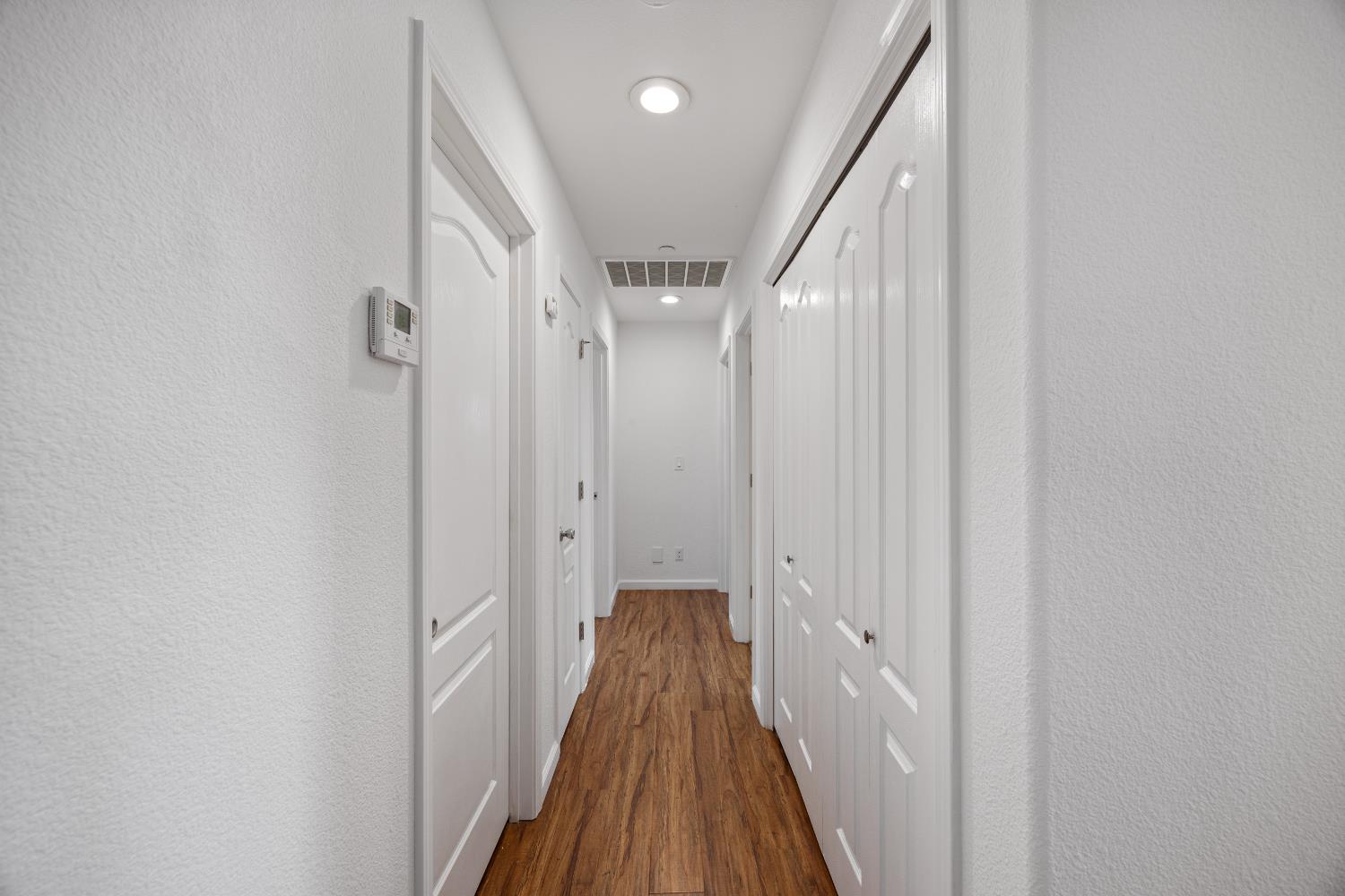 8009 Spring Valley Road Pollock Pines, CA 95726 - Photo 13 of 31 a view of a hallway with wooden floor and staircase