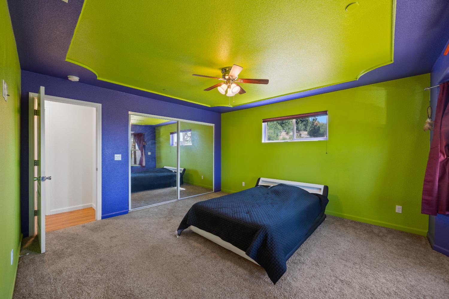 8009 Spring Valley Road Pollock Pines, CA 95726 - Photo 20 of 31 a bed room with a bed and a chandelier