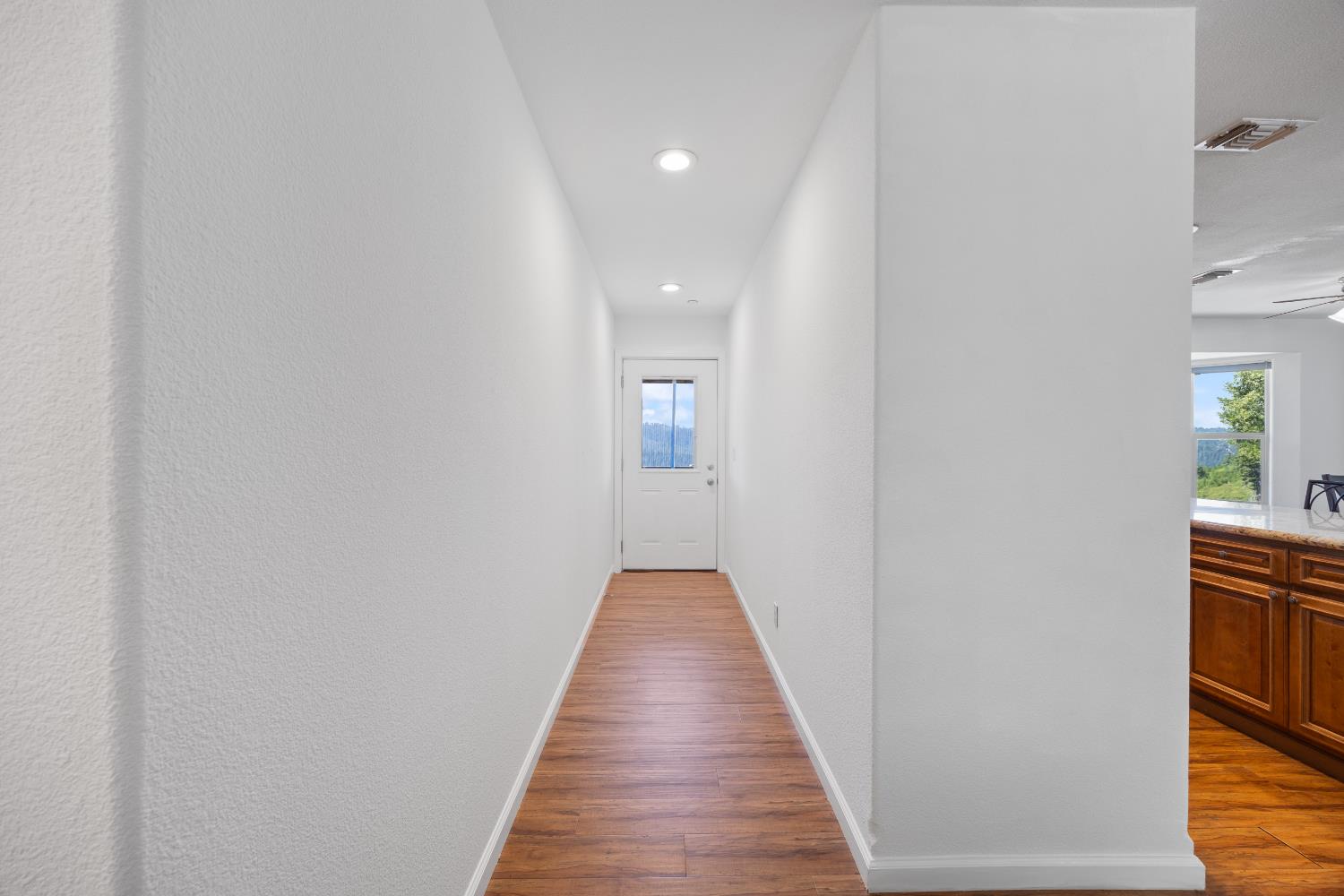 8009 Spring Valley Road Pollock Pines, CA 95726 - Photo 6 of 31 a view of a hallway with wooden floor and staircase