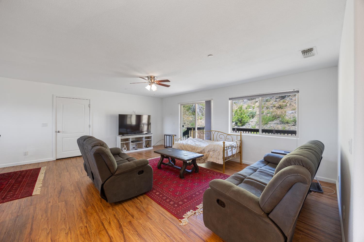 8009 Spring Valley Road Pollock Pines, CA 95726 - Photo 10 of 31 a living room with furniture and a flat screen tv