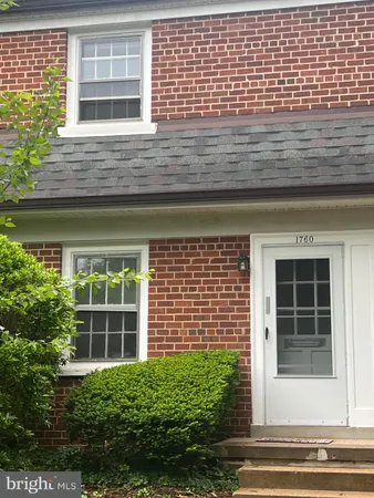a view of a brick house with a large windows