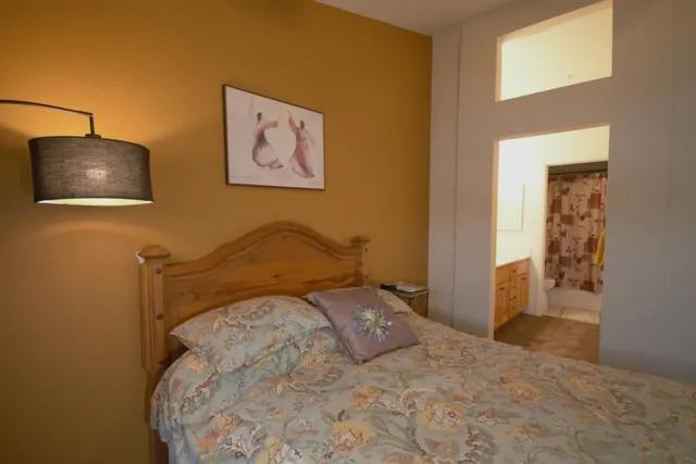 a bedroom with a bed and a wall painting