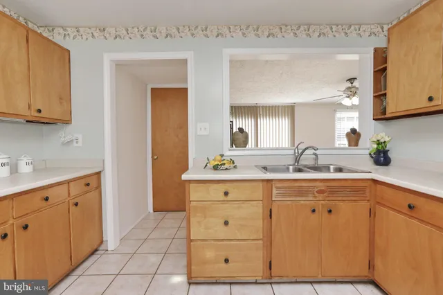 a spacious bathroom with a granite countertop sink and a mirror