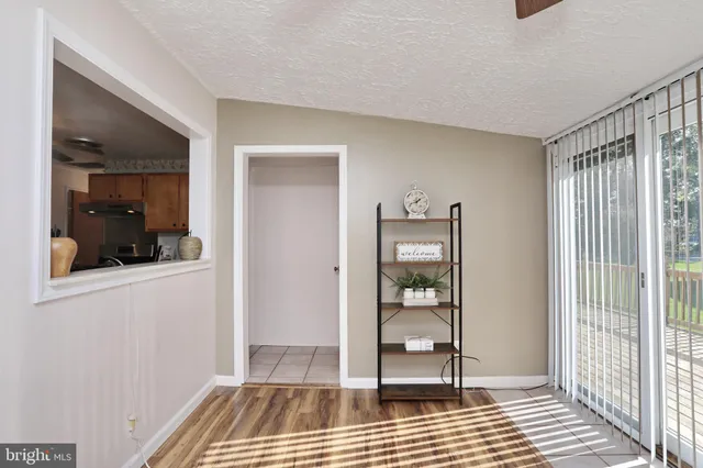 a view of a room with wooden floor and windows