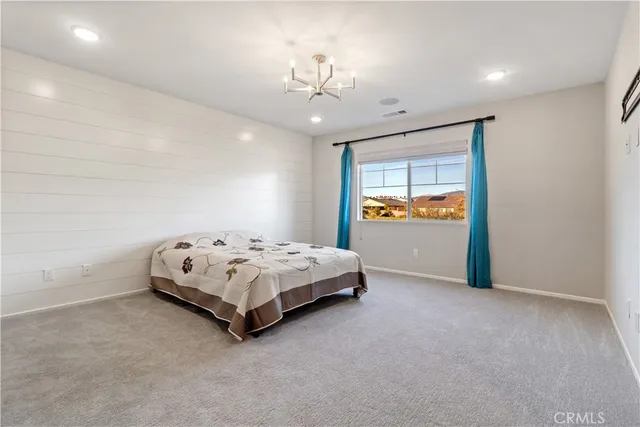 a spacious bedroom with a bed and window