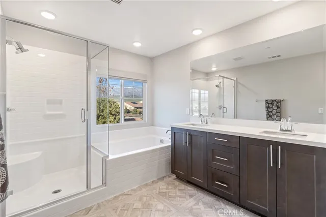 a bathroom with a bathtub shower sink and mirror