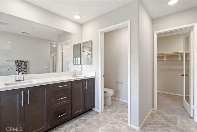 a spacious bathroom with a bathtub sink mirror and toilet