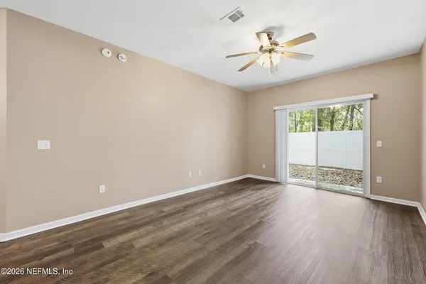 wooden floor in an empty room with a window