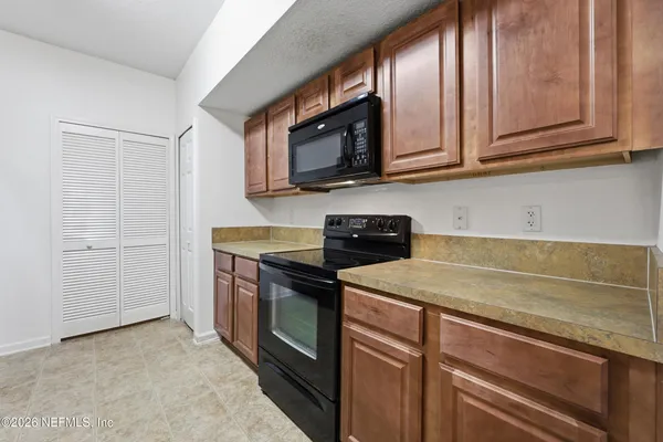a kitchen with stainless steel appliances granite countertop a sink stove and microwave