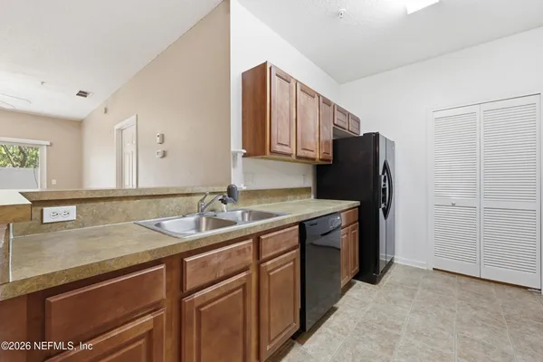 a kitchen with a sink appliances and cabinets