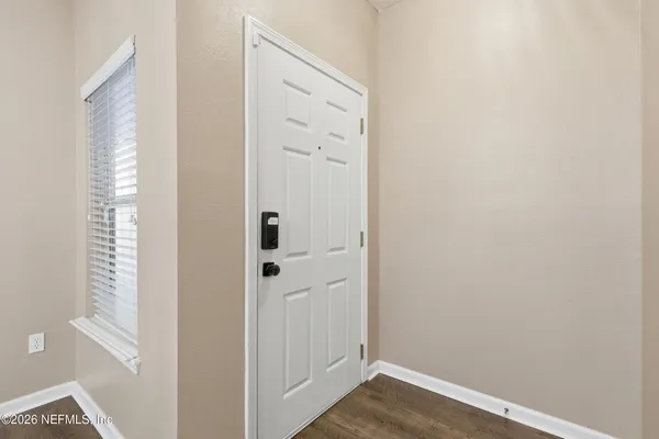 a view of a hallway with wooden floor