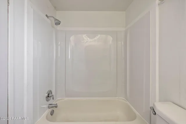 a bathroom with a tub and shower