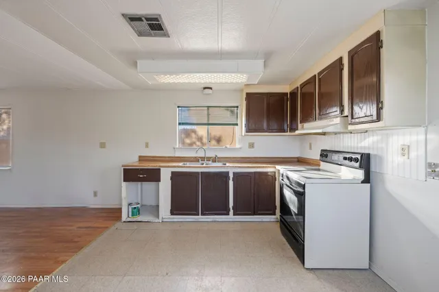 a kitchen with stainless steel appliances granite countertop a stove and a sink