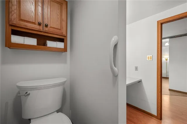 a white toilet sitting next to a shower