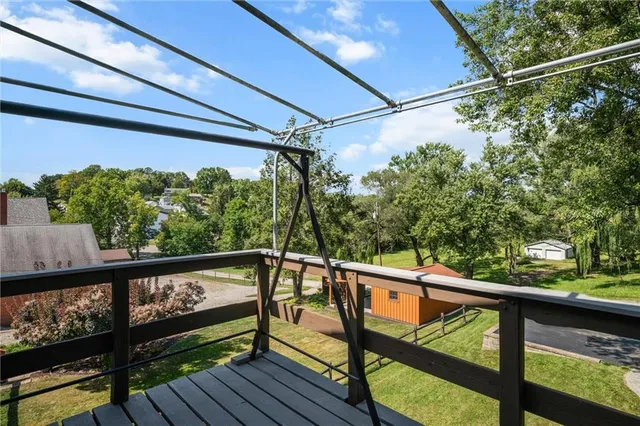a view of a balcony with wooden floor