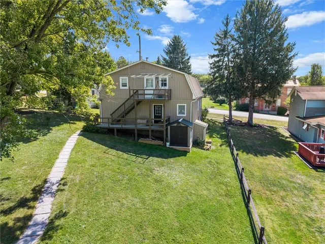 a view of a house with backyard porch and sitting area