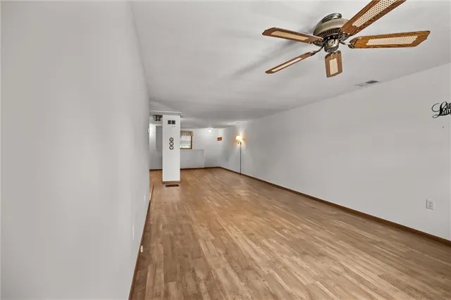 a view of empty room with wooden floor