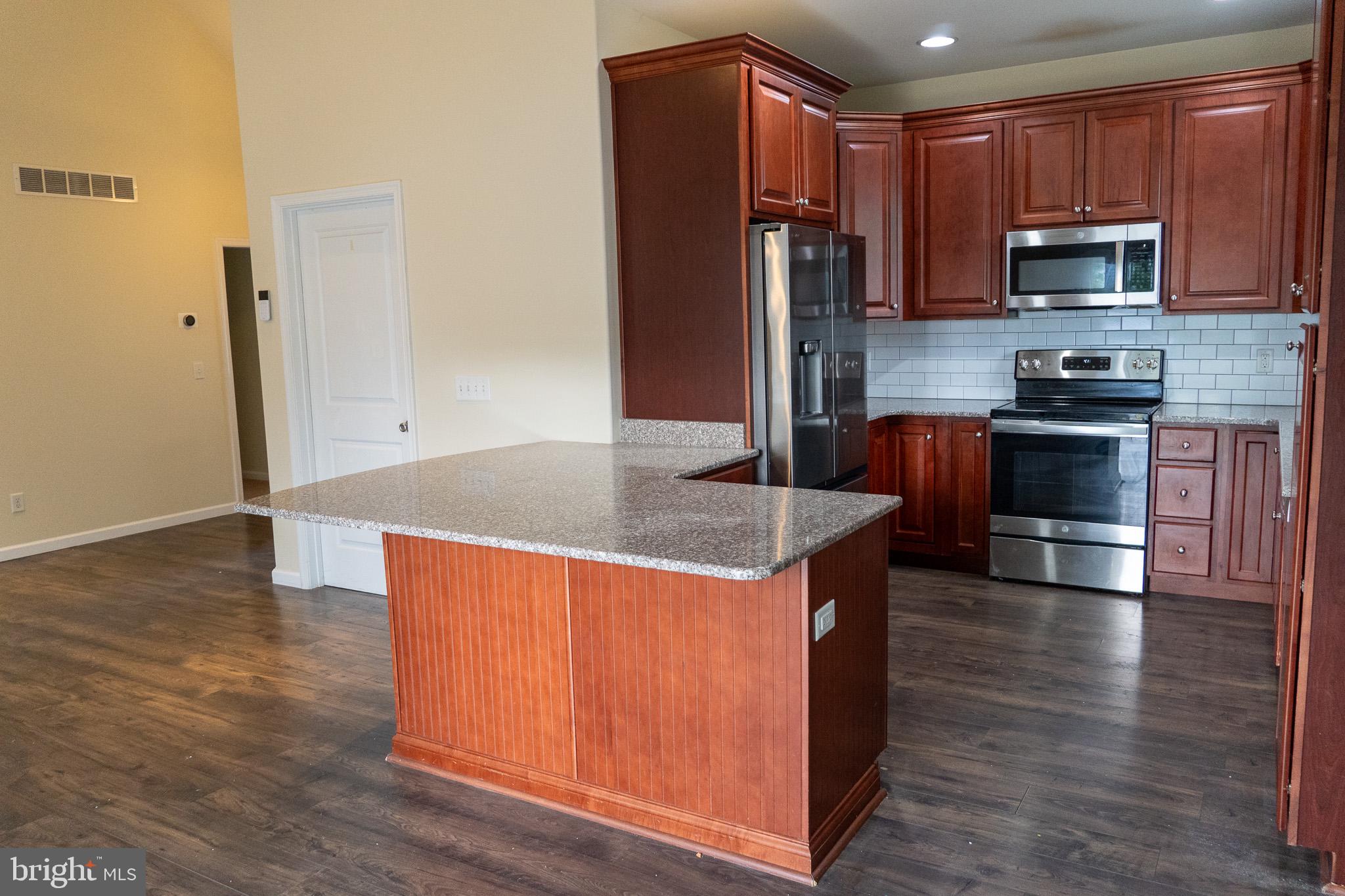 27 Sun Ridge Drive Felton, DE 19943 - Photo 12 of 41 Modern kitchen with rich wood accents.