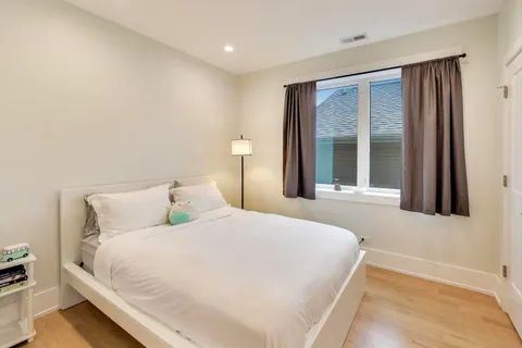 a bedroom with a large bed and a large window