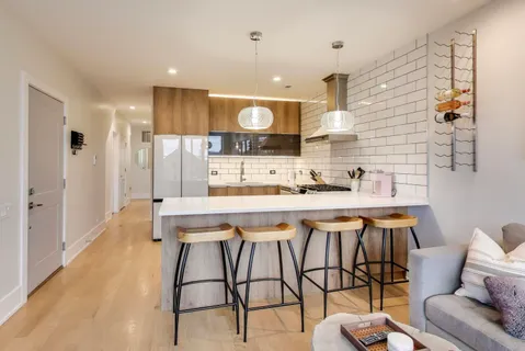 a kitchen with stainless steel appliances kitchen island granite countertop a sink and cabinets