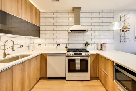 a kitchen with a sink stove and cabinets