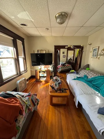 a living room with furniture fireplace and a large window