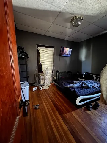 a living room with furniture gym equipment and a flat screen tv