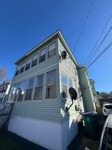 a balcony with table and chairs