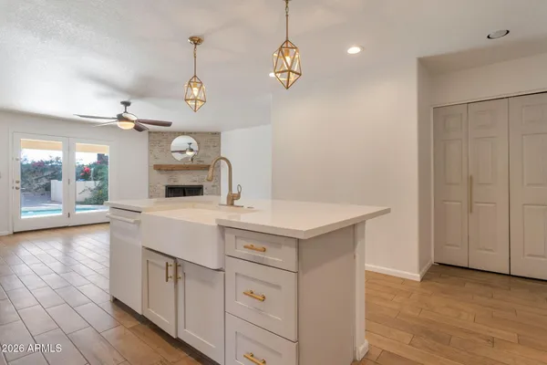 a kitchen with a sink dishwasher a stove and a refrigerator with wooden floor