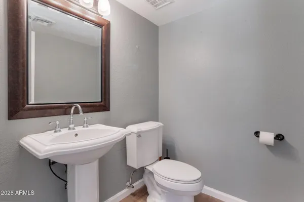 a bathroom with a sink a toilet and mirror