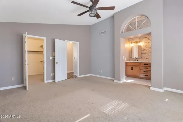 an empty room with a bathroom and mirror