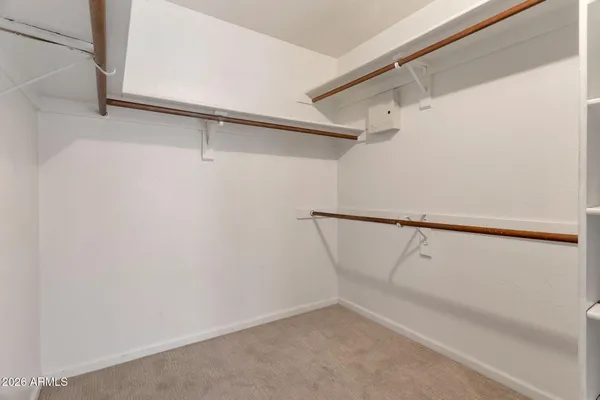 a view of walk in closet with empty racks