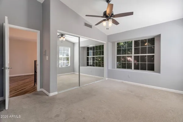 an empty room with chandelier fan
