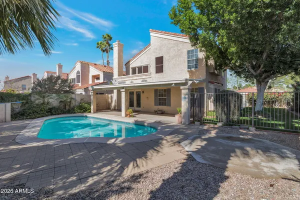 a view of a house with a yard and large tree