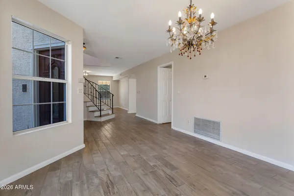 a view of a room with wooden floor and a window