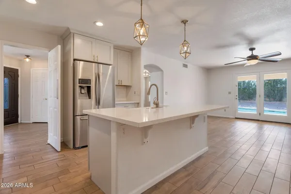 a kitchen with stainless steel appliances a sink and a refrigerator