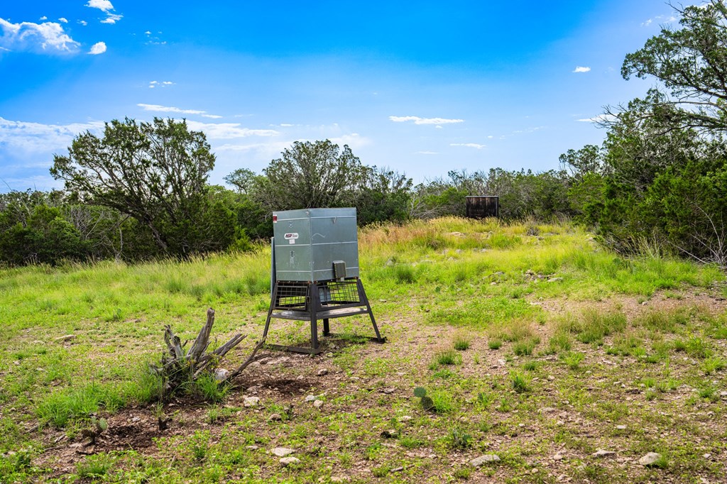 230 Camino Real Road Northwest Junction, TX 76849 - Photo 23 of 26 a view of a lake with a bench in front of house