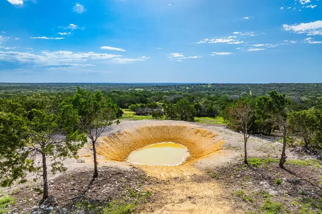 a view of a swimming pool with a yard