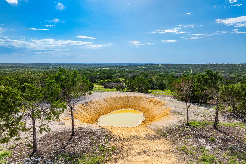 230 Camino Real Road Northwest Junction, TX 76849 - Photo 5 of 26 a view of a swimming pool with a yard
