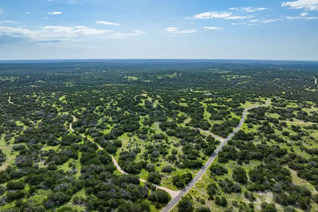 an aerial view of residential houses with city view