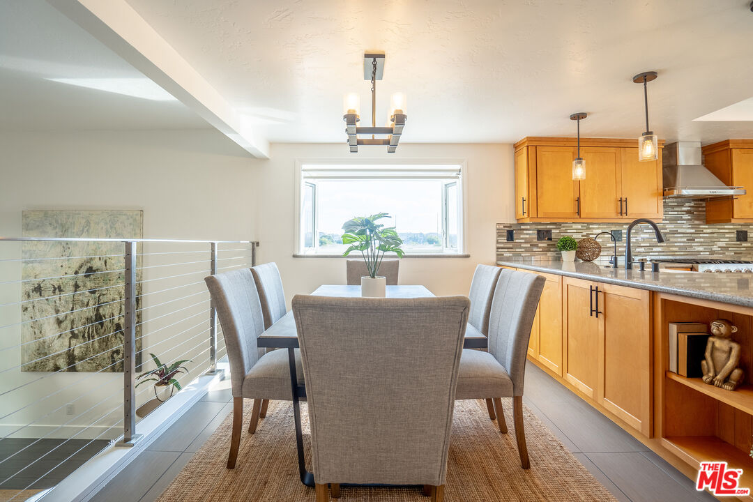 13214 Fiji Way, Unit T Marina del Rey, CA 90292 - Photo 12 of 31 a dining room with furniture window and wooden floor