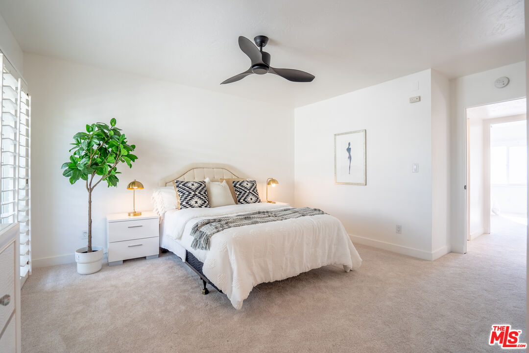 13214 Fiji Way, Unit T Marina del Rey, CA 90292 - Photo 16 of 31 a bedroom with a bed and a potted plant