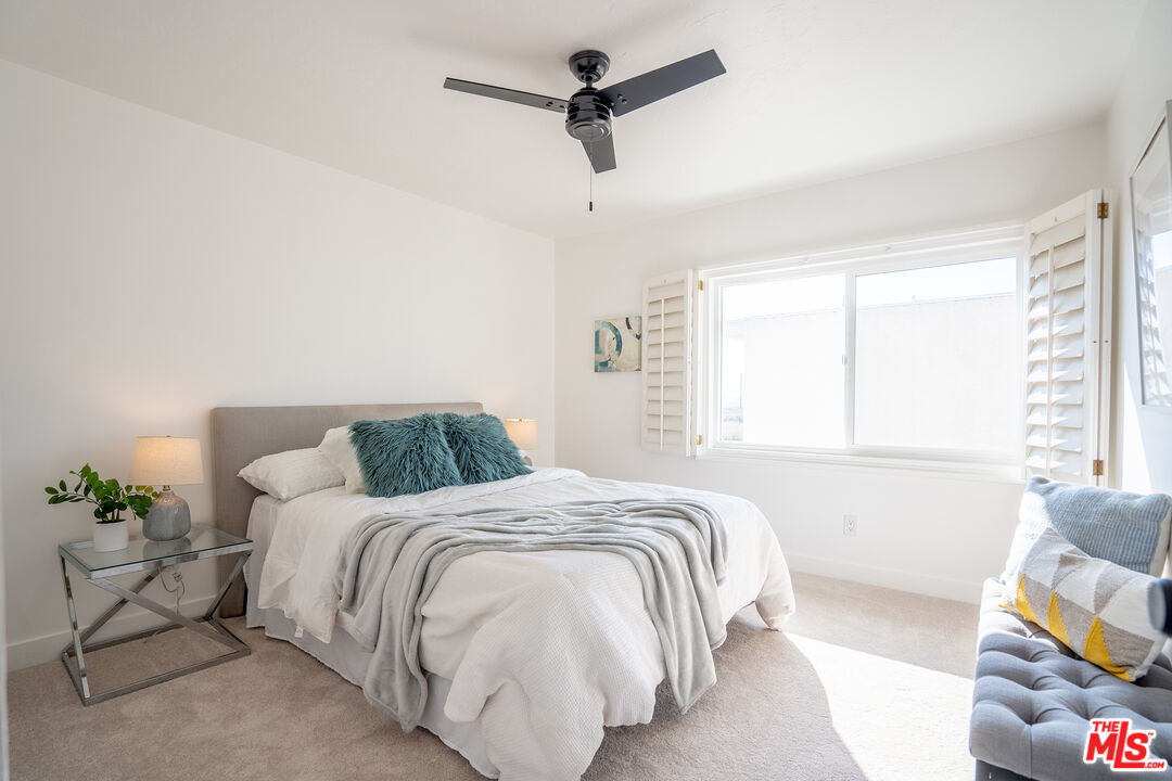 13214 Fiji Way, Unit T Marina del Rey, CA 90292 - Photo 20 of 31 a bedroom with a bed a window and a potted plant