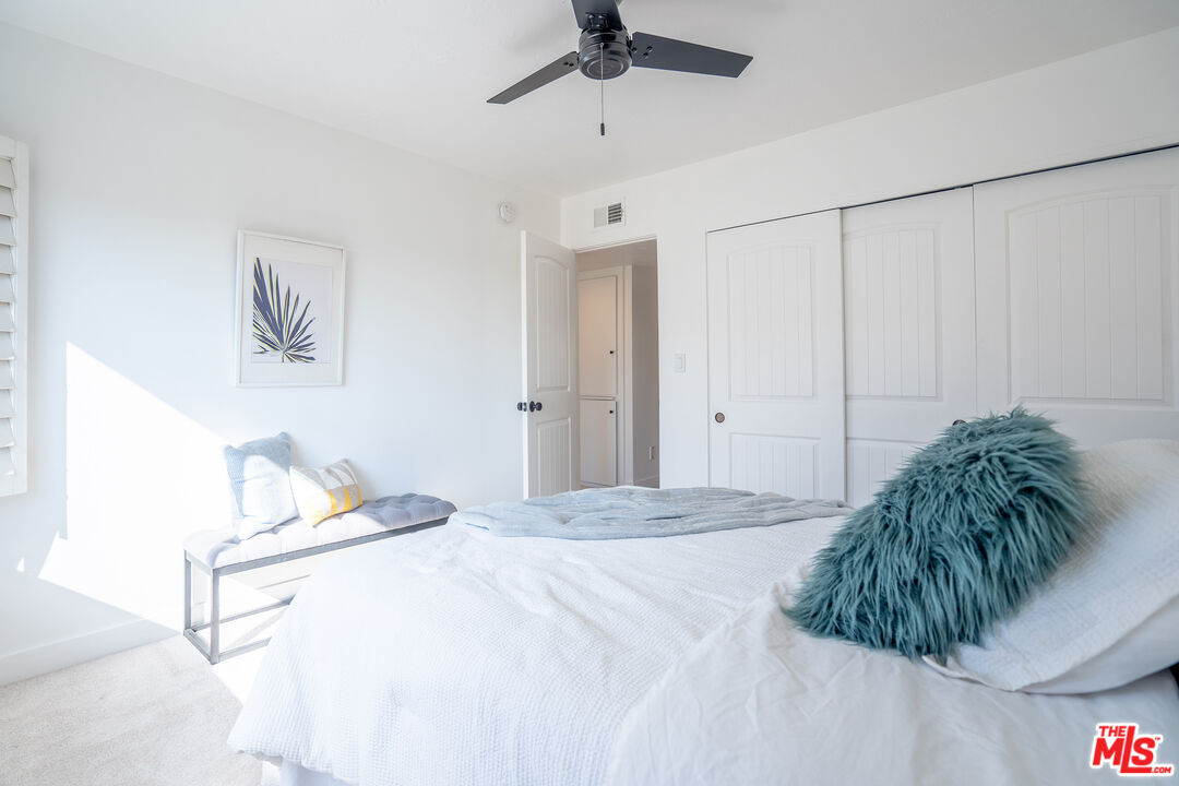 13214 Fiji Way, Unit T Marina del Rey, CA 90292 - Photo 21 of 31 a bedroom with a bed and a ceiling fan