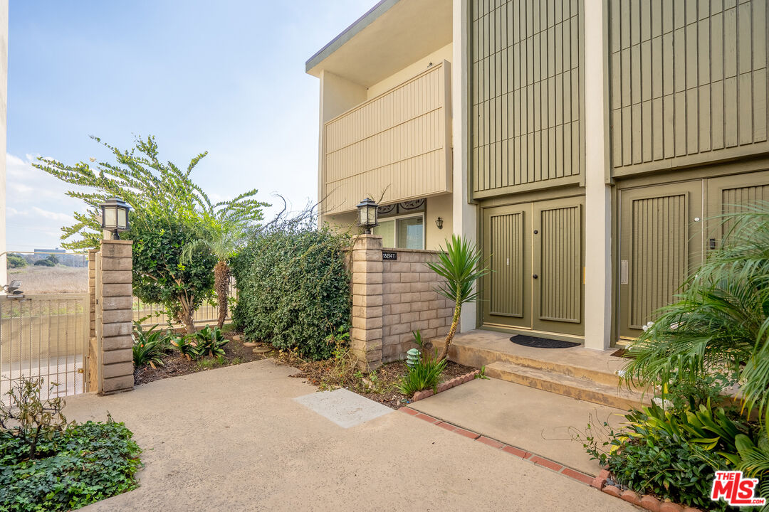 13214 Fiji Way, Unit T Marina del Rey, CA 90292 - Photo 25 of 31 a front view of a house with a garden