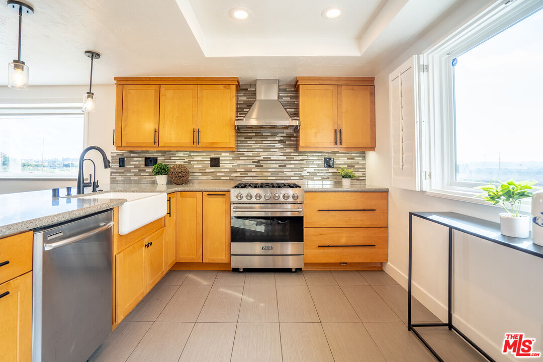13214 Fiji Way, Unit T Marina del Rey, CA 90292 - Photo 7 of 31 a kitchen with stainless steel appliances a stove sink and cabinets