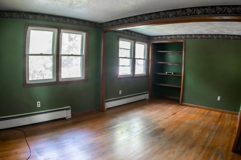 47 Craig Street Springfield, MA 01108 - Photo 11 of 18 an empty room with wooden floor and windows