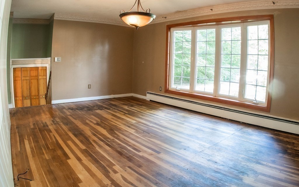47 Craig Street Springfield, MA 01108 - Photo 7 of 18 an empty room with wooden floor and windows